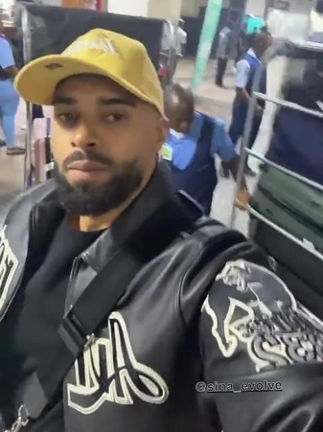 Abdul Latif in a yellow cap and black jacket.