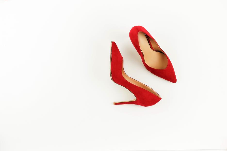 Pair of red high-heeled shoes on a white background.