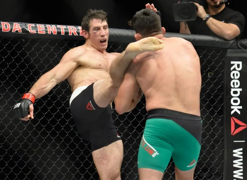 Tim Kennedy kicks Kelvin Gastelum during a middleweight bout at UFC 206.