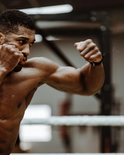 Anthony Joshua training in a boxing ring.