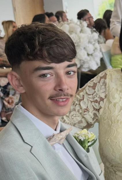 Jaydon Bowyer in a light suit with a bow tie and boutonnière.