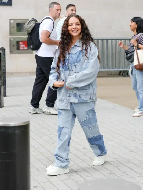 Jade Thirlwall wearing a matching denim jacket and pants outside a studio.