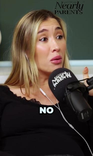 Sophie Habboo, wearing an earpiece and black shirt, says “NO” into a microphone for the “Nearly Parents” podcast.