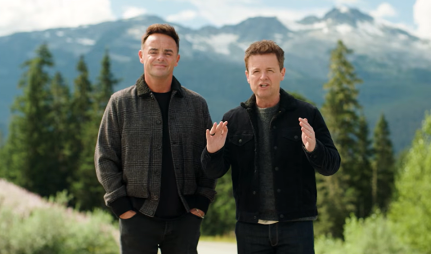 Ant and Dec standing outdoors in front of mountains and trees.