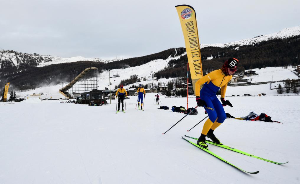 A man cross-country skiing in Livigno, which will host Snowboard and Freestyle Skiing events for the Milano Cortina 2026 Olympic Games.