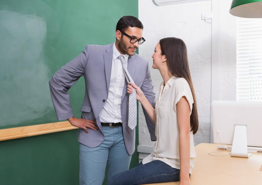 Businessman and businesswoman flirting in an office.