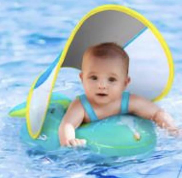 Baby in a blue float with a yellow sunshade in a pool.