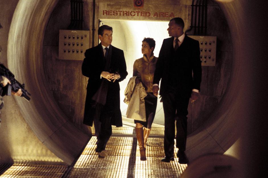 Pierce Brosnan, Halle Berry, and Colin Salmon walking through a tunnel in "Die Another Day."