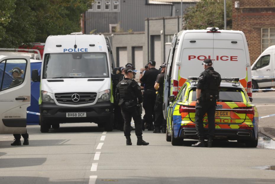 Police officers at a murder investigation scene.