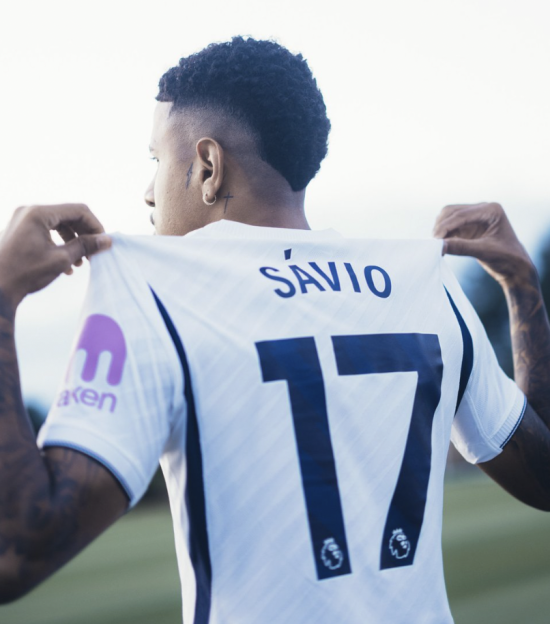 Savio wearing a white soccer jersey with his name and the number 17 on the back.