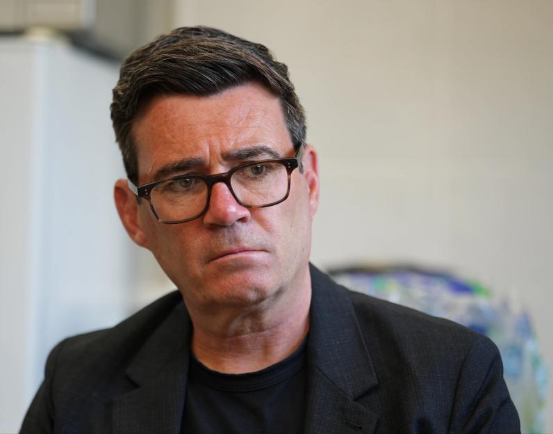 Andy Burnham, the Labour Makerfield by-election candidate, listening intently during a meeting with flood victims.