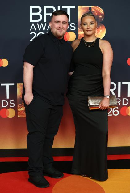 Luke Littler and Faith Millar pose on the red carpet at the BRIT Awards 2026.