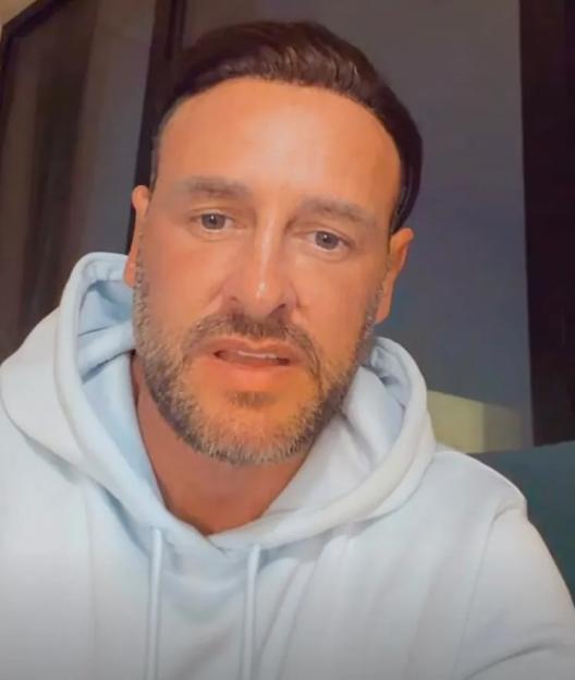 Lee Andrews wearing a white hoodie.