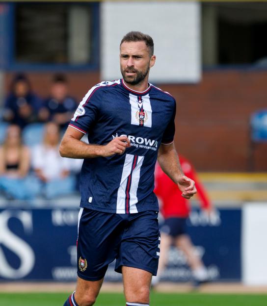 Clark Robertson wearing a navy and white striped football kit.