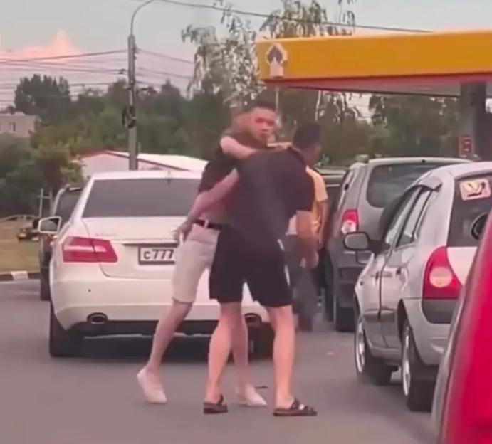 Russian motorists fight at petrol stations amidst growing fuel crisis caused by Ukrainian strikes on Vladimir Putins oil refineries.. Two men fight in the queue at a petrol station in Ryazan.