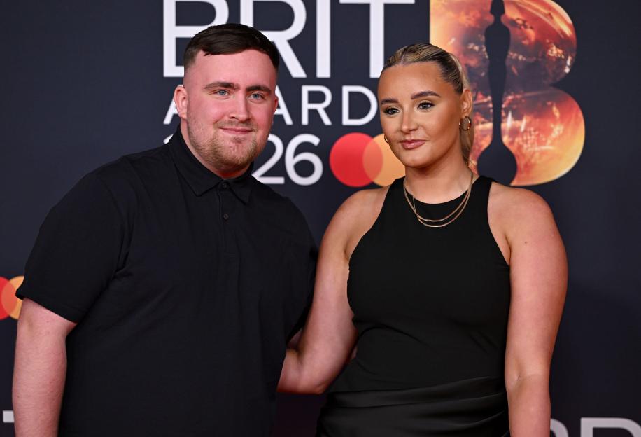 Luke Littler and Faith Millar posing together at The Brit Awards 2026.