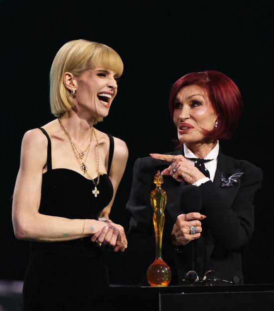 Kelly Osbourne and Sharon Osbourne on stage accepting the Lifetime Achievement Award for Ozzy Osbourne.