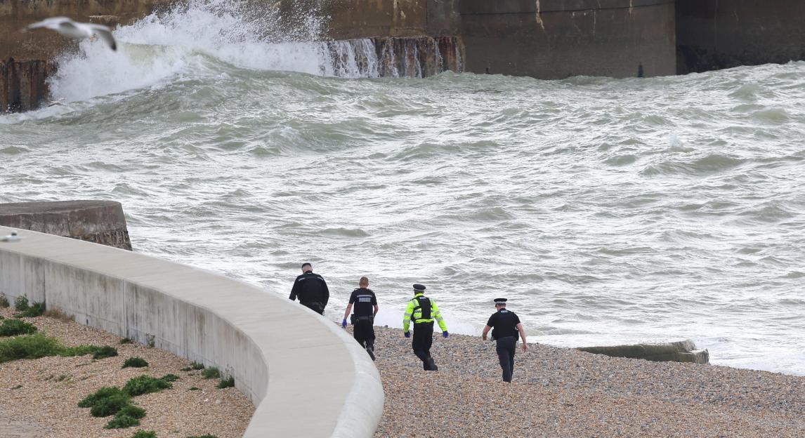 Emergency services on Brighton beach after the discovery of three bodies in the water.