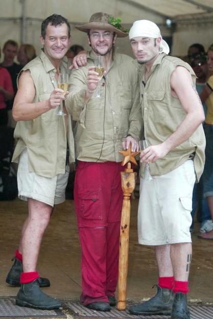 Paul Burrell, Joe Pasquale, and Fran Cosgrave from "I'm a Celebrity...Get Me Out of Here!" holding champagne glasses.