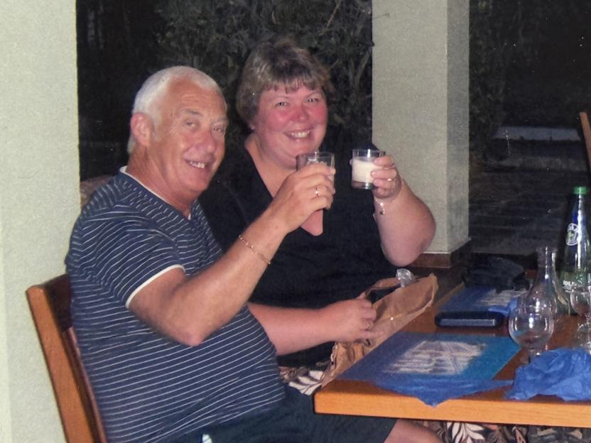 David and Lynn Bryant smiling with drinks in hand.