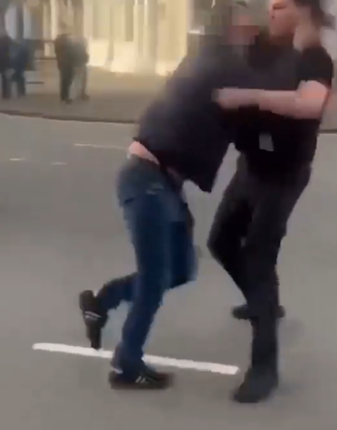 Two men clashing during violent disorder.