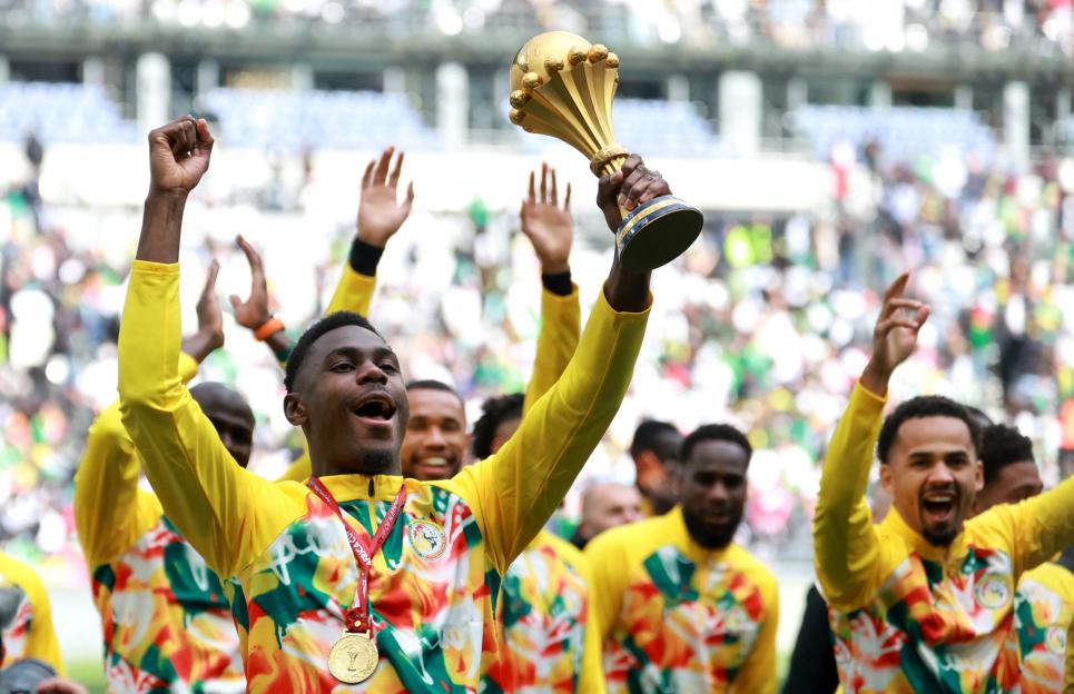 Senegal players celebrate with the CAF Africa Cup of Nations trophy before the match.