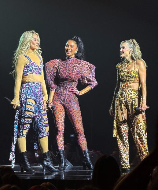 The Pussycat Dolls Nicole Scherzinger, Ashley Roberts, and Kimberly Wyatt performing on stage during their tour.