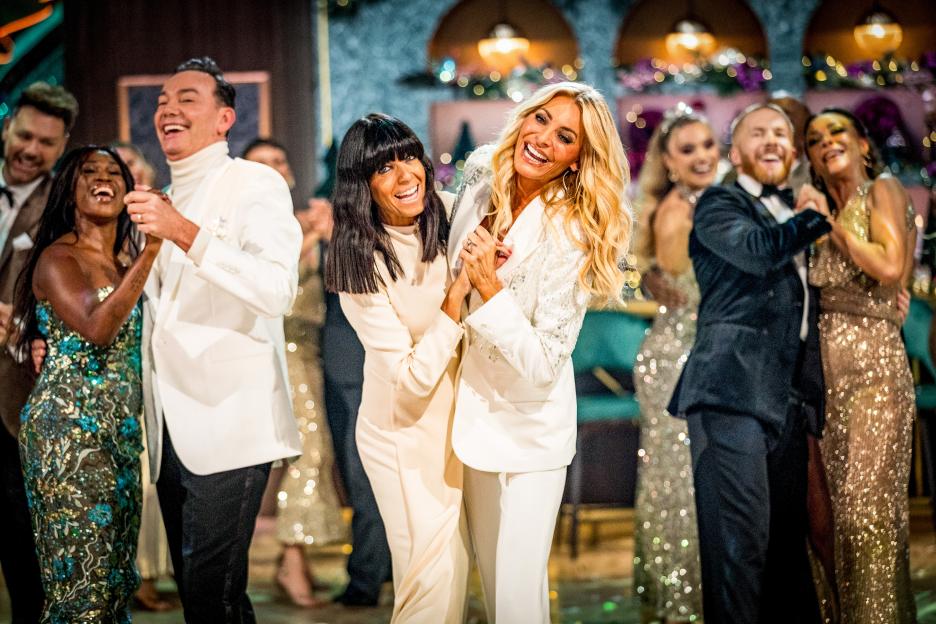 Presenters Claudia Winkleman and Tess Daly laughing with other dancers on the Strictly Come Dancing Christmas Special 2025.