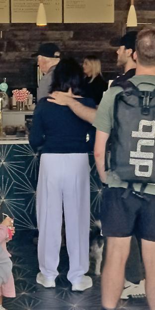 Shirley Ballas and Giuseppe Nonnis getting coffee, with Nonnis's hand on Ballas's neck and back.