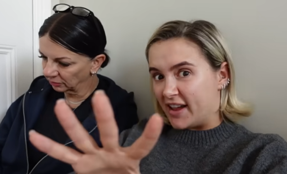 Two women, one with dark hair and glasses on her head, and another with blonde hair gesturing with an open hand towards the camera.