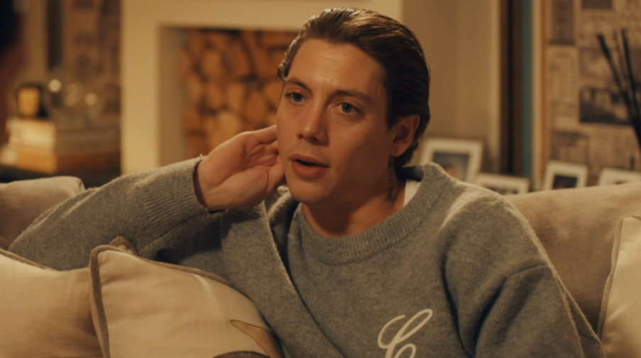 Sam Vanderpump from Channel 4 sitting on a couch.