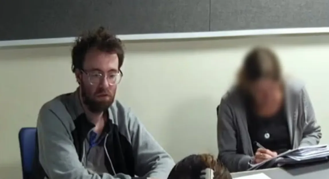 Joshua Powell sitting in a police interview room refusing to answer questions.