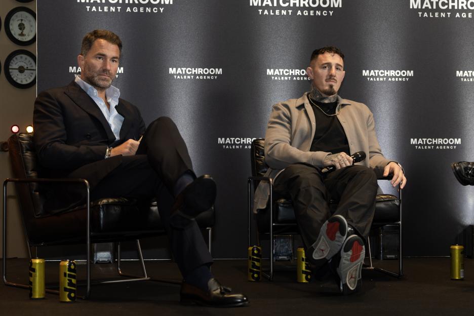 Eddie Hearn and Tom Aspinall sitting on stage at the Matchroom Talent Agency launch press conference.