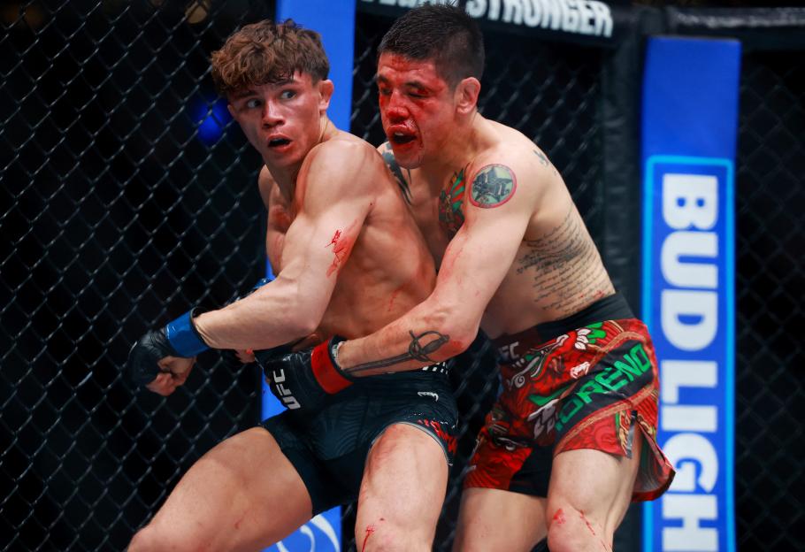 Lone'er Kavanagh grappling with Brandon Moreno during a UFC Fight Night event.
