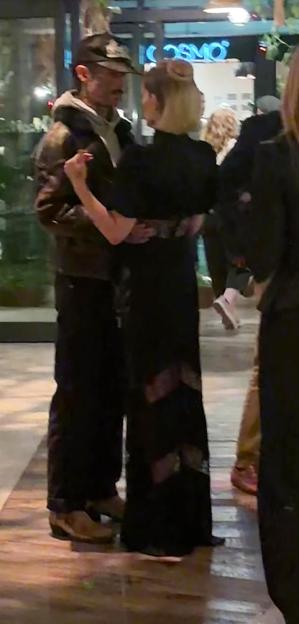 Kelly Osbourne and Brad North slow dancing.