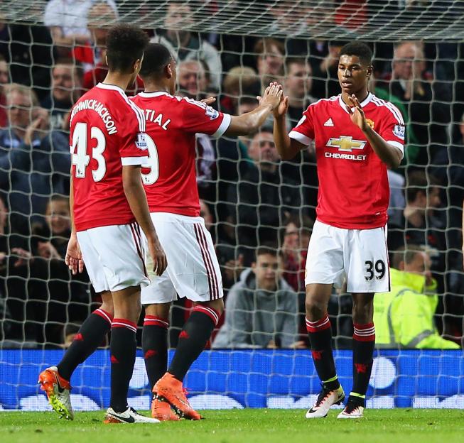 MANCHESTER, ENGLAND - MAY 17: Marcus Rashford of Manchester United (39) celebrates with Anthony Martial (9) and Cameron Borthwick-Jackson (43) as he scores their second goal during the Barclays Premier League match between Manchester United and AFC Bournemouth at Old Trafford on May 17, 2016 in Manchester, England. (Photo by Alex Livesey/Getty Images)