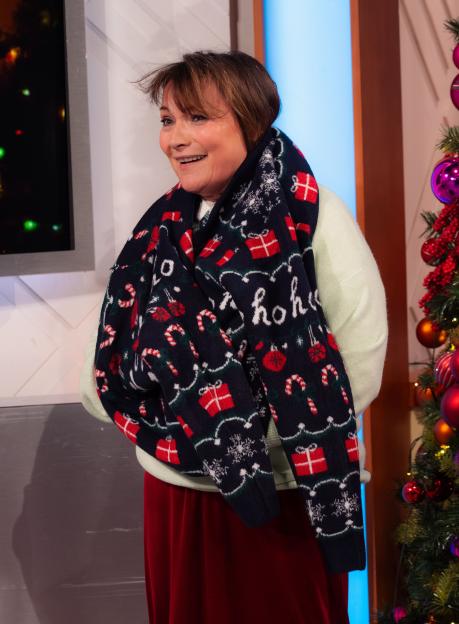 Lorraine Kelly in a festive scarf and red skirt on the "Lorraine" TV show.