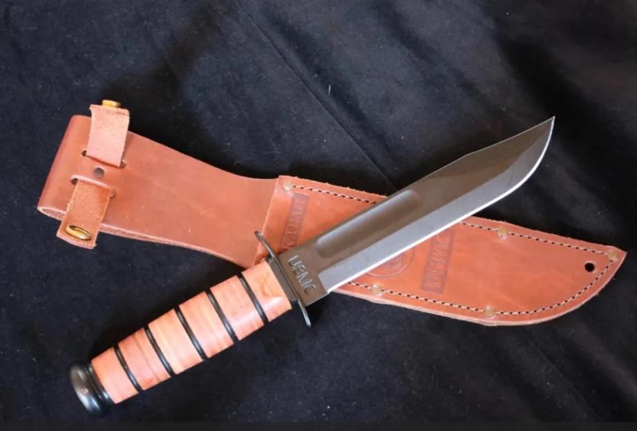 Ka-Bar knife with a brown leather sheath.