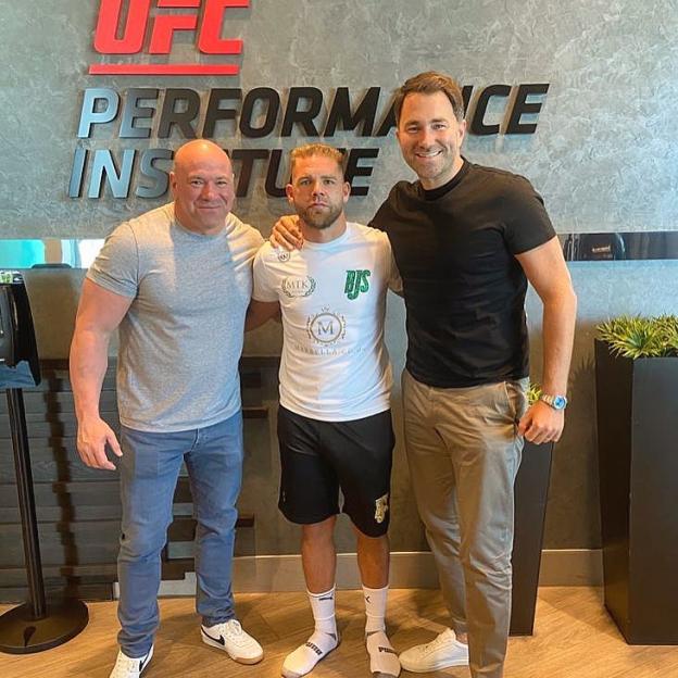 Dana White, Billy Joe Saunders, and Eddie Hearn posing in front of a UFC Performance Institute sign.