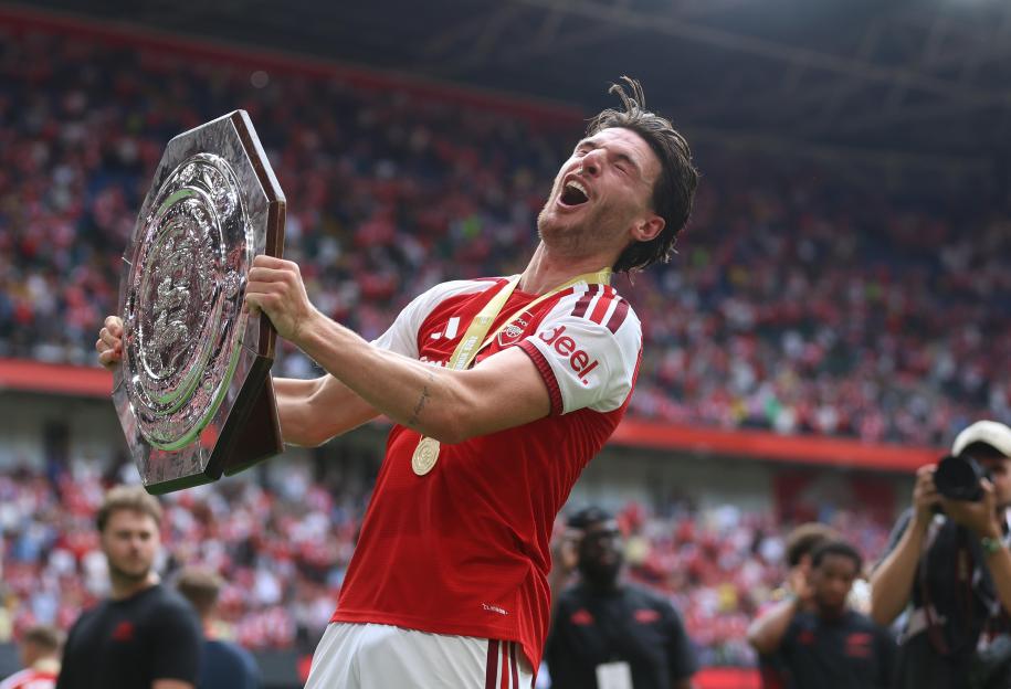 Cardiff, UK. 16th Aug, 2026. CARDIFF, WALES, AUGUST 16: Declan Rice of Arsenal has himself on the head with the stand of the shield as he holds aloft the FA Community Shield in celebration after winning the 2026 FA Community Shield during the FA Comm