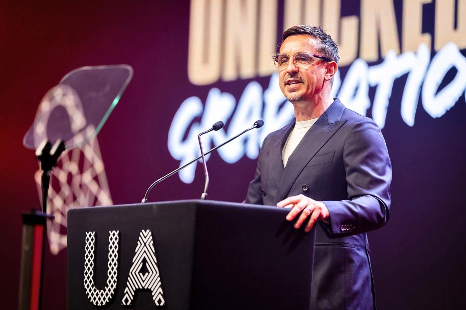 Gary Neville speaking at a graduation ceremony.