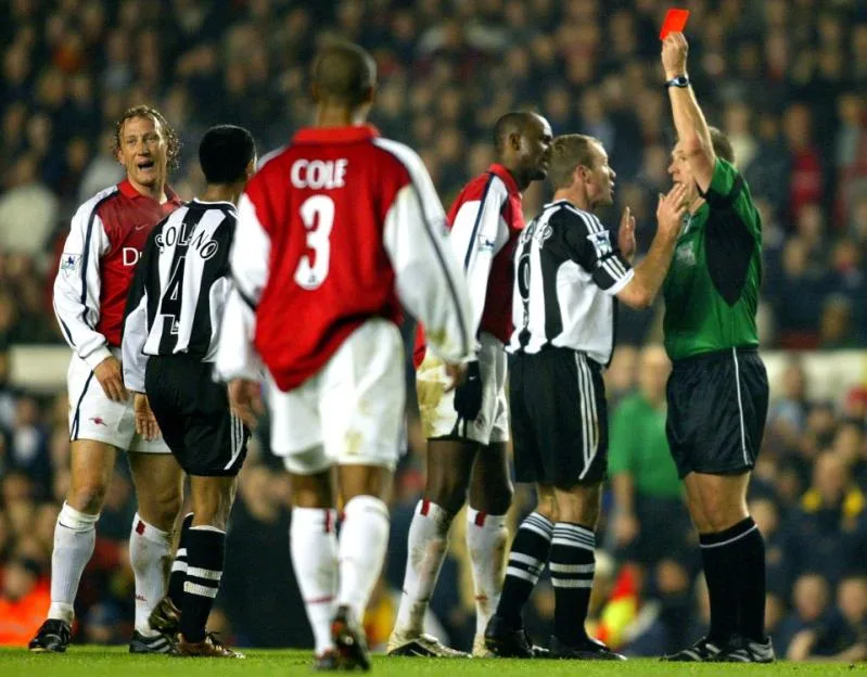Referee Graham Poll shows Arsenal's Ray Parlour a red card during a match against Newcastle United.