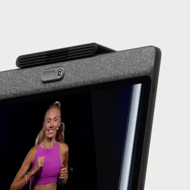 A fitness trainer on a screen with a camera, fan, and textured border.