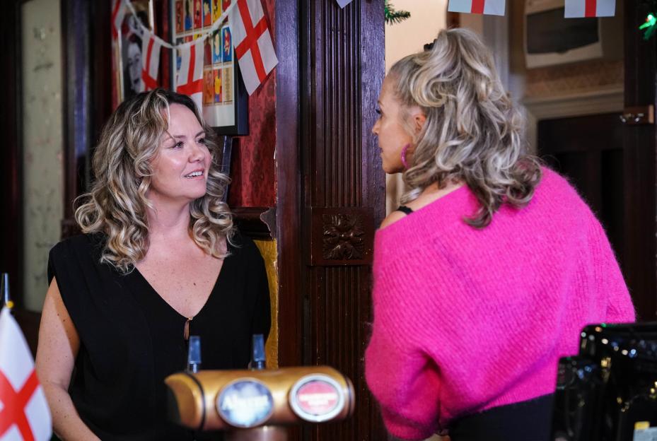 Janine Butcher and Linda Carter talking at the bar.