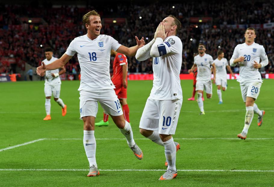 Harry Kane celebrates with Wayne Rooney after Rooney scored his record-breaking 50th goal for England.