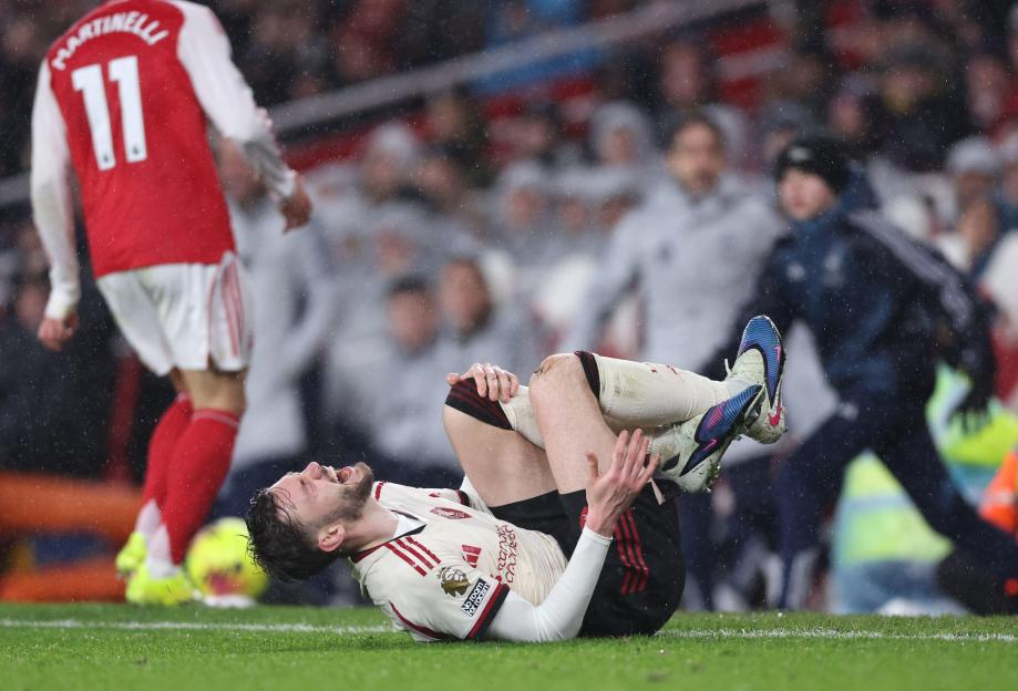 Conor Bradley of Liverpool injured during a Premier League match.
