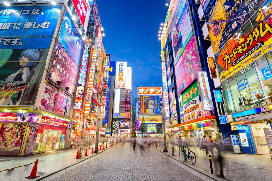 Akihabara, Tokyo, Japan street scene with buildings covered in colorful advertisements and bright signs.