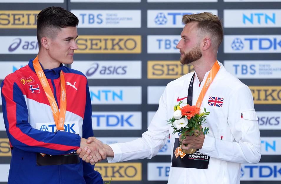 Great Britain's gold medalist Josh Kerr shakes hands with silver medalist Norway?s Jakob Ingebrigtsen during the medal ceremony for the Men's 1500 Metres on day seven of the World Athletics Championships at the National Athletics Centre in Budapest,