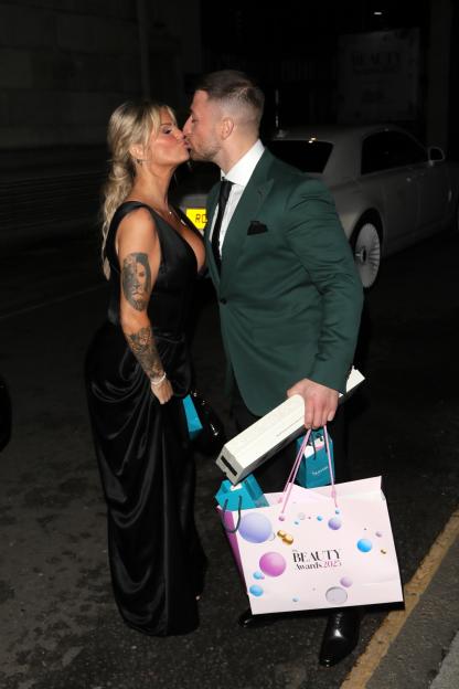 Kerry Katona shows off the results of her recent boob job as she snogs 12 years younger boyfriend on red carpet