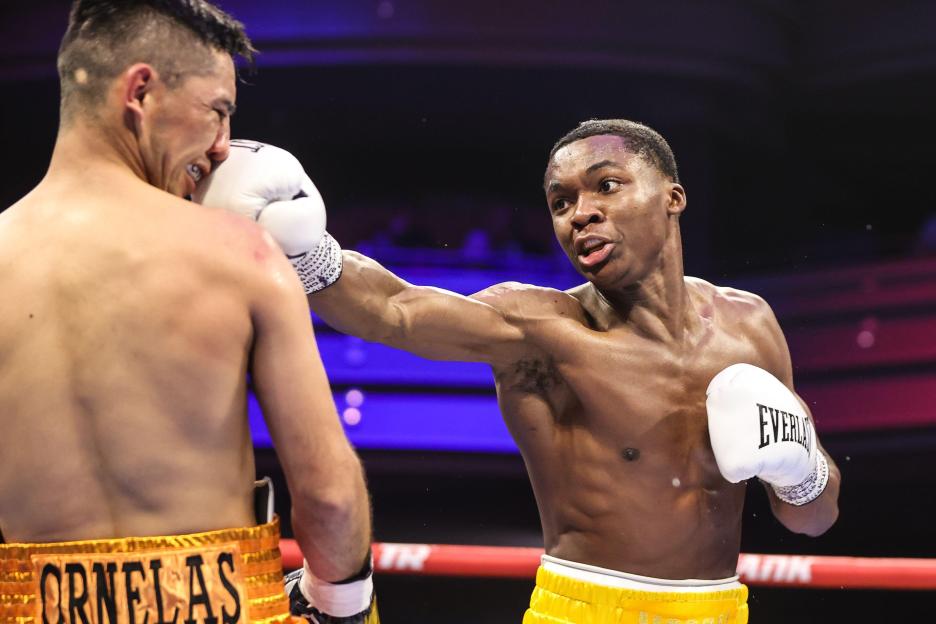 Abdullah Mason punching Carlos Ornelas in the face during a boxing match.
